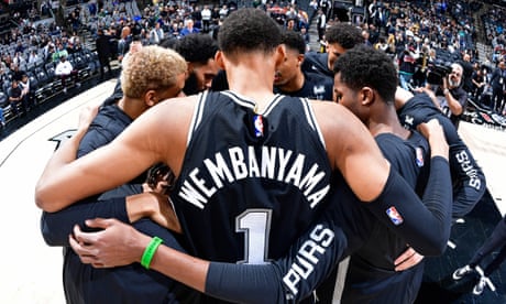 Victor Wembanyama huddles with his San Antonio Spurs teammates before a January game against the Milwaukee Bucks at the Frost Bank Center in San Antonio, Texas.
