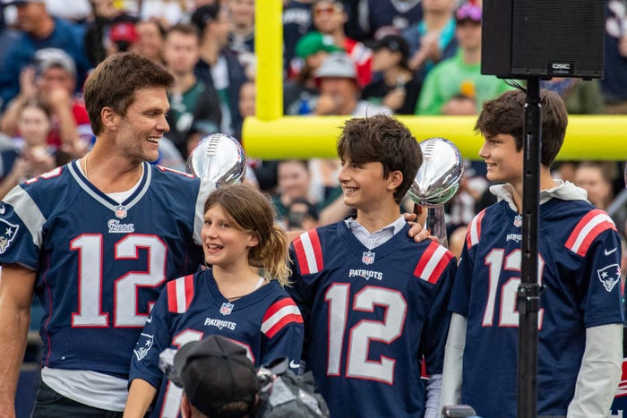 Tom Brady (L) stands with his children during a "Thank You" celebration honoring the former New England Patriots' quarterback during half time of the home opening game for the New England Patriots on September 10, 2023 in Foxborough, Massachusetts. Brady played for 20 seasons with the New England Patriots.